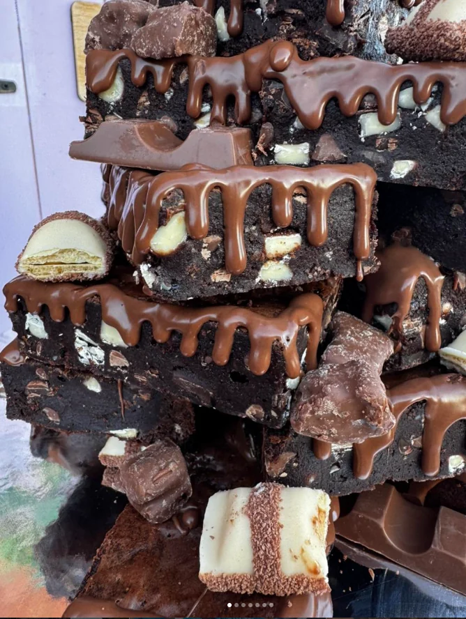 Stack of rich chocolate brownies topped with chocolate